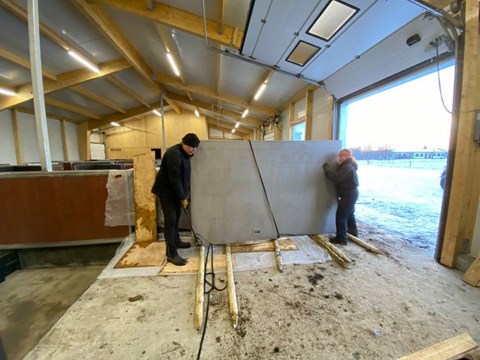How do you get a 300 kg fire door from the trailer into the barn?
